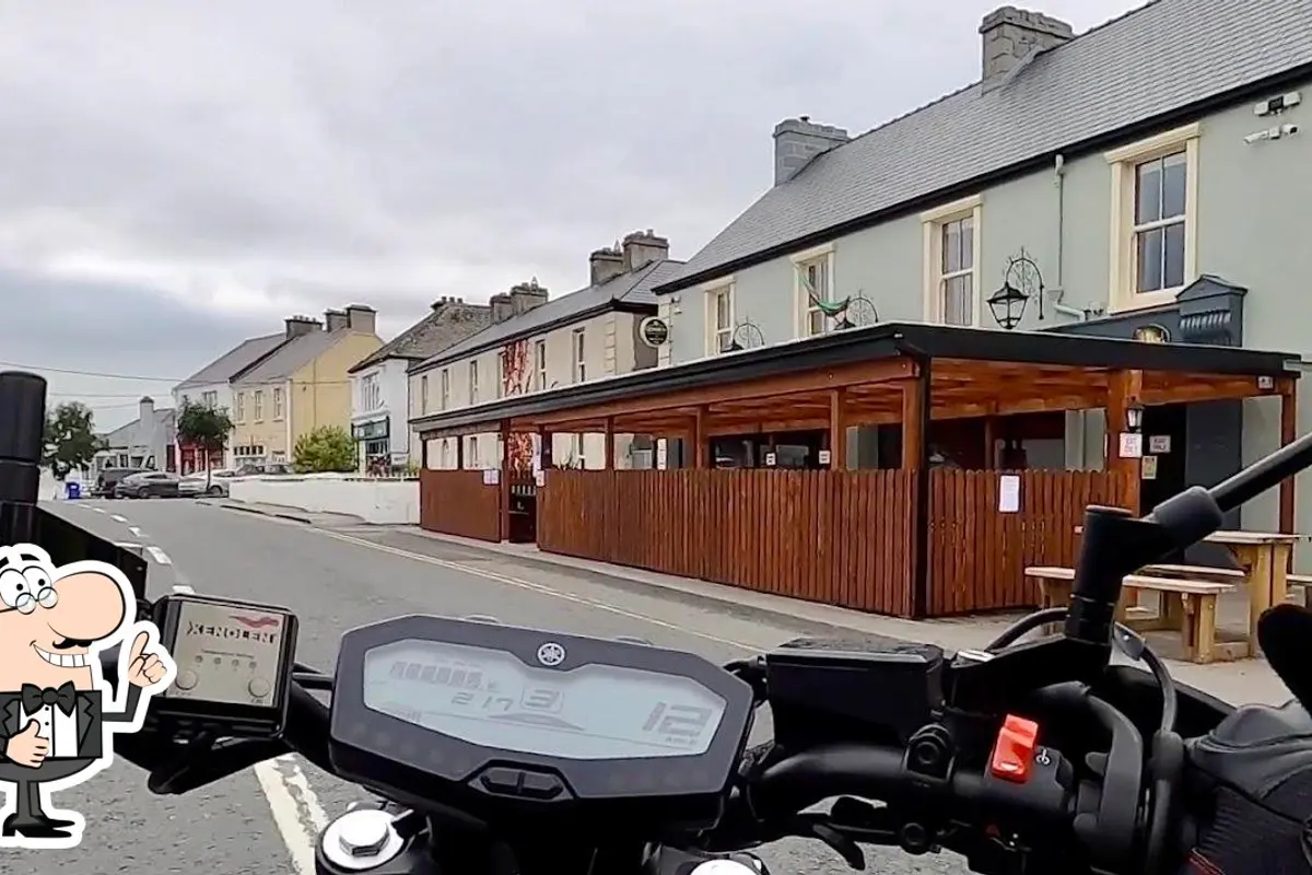 McNulty's Pub from Main Street showing the covered outdoor terrace and pale green facade