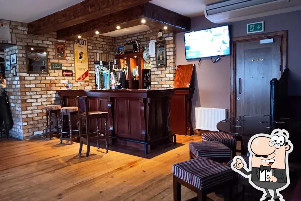 Inside McNulty's Pub showing the wooden bar counter, exposed brick walls, and warm lighting